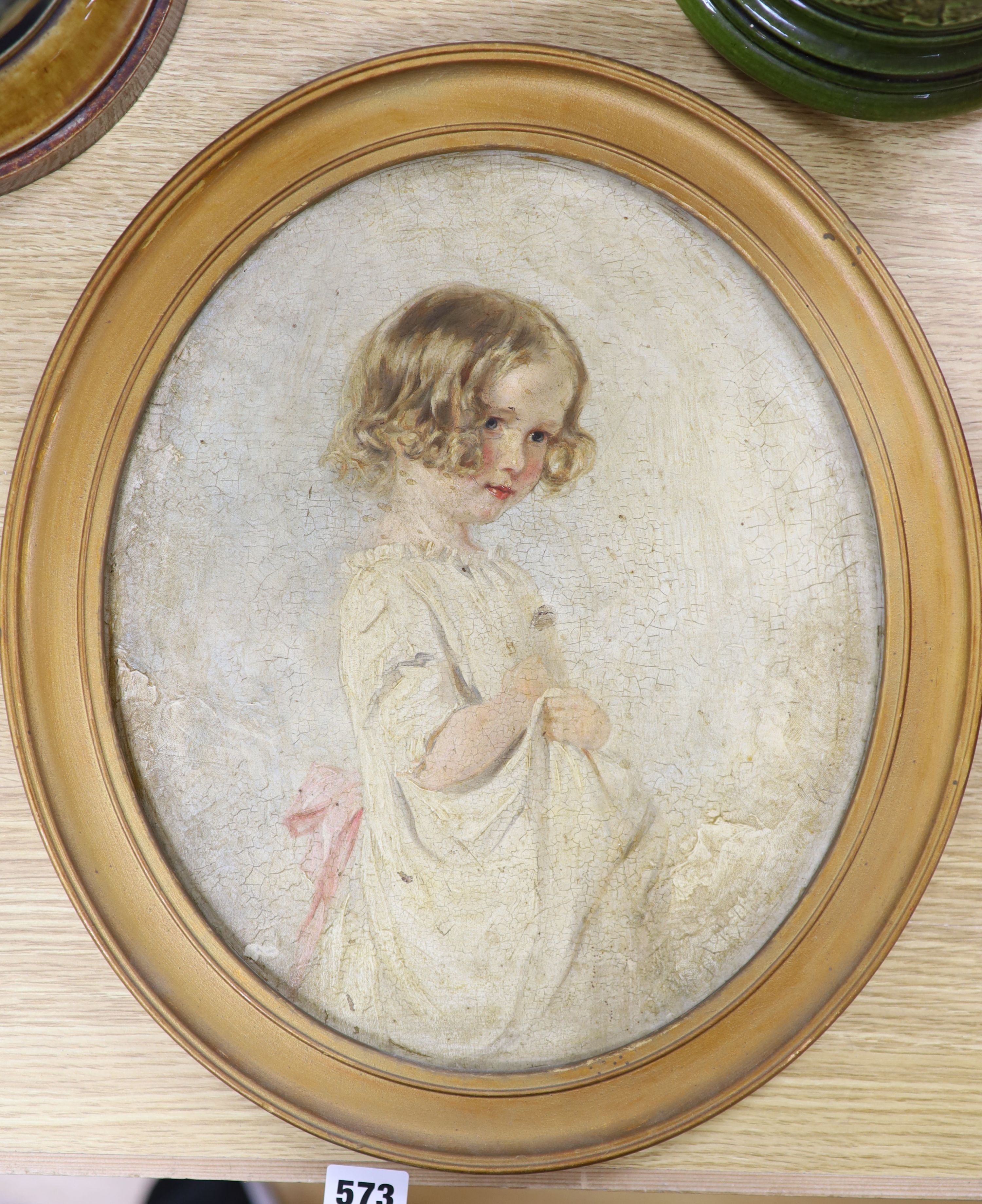 Early 20th century English School, oil on board, Portrait of a young girl, oval, 34 x 29cm